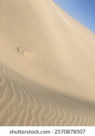 Wavey sand dunes in remote Peru desert