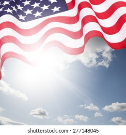 Waving American Flag Under Blue Sky