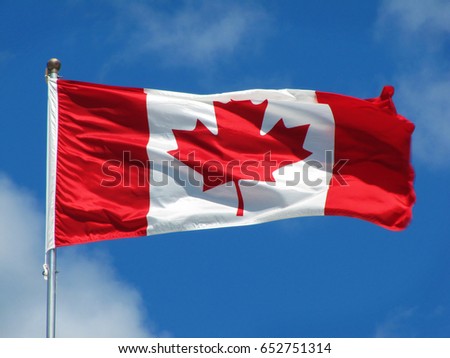 Waving Canadian flag against the blue sky