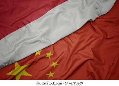 Waving Colorful Flag Of China And National Flag Of Indonesia. Macro