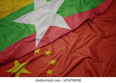 Waving Colorful Flag Of China And National Flag Of Myanmar. Macro