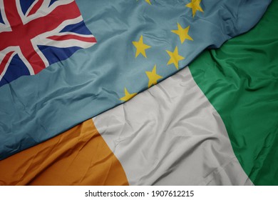 waving colorful flag of cote divoire and national flag of Tuvalu . macro