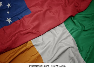 waving colorful flag of cote divoire and national flag of Samoa . macro