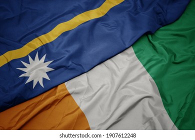 waving colorful flag of cote divoire and national flag of Nauru . macro