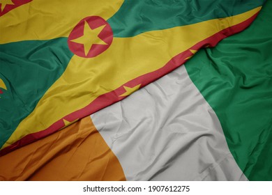 waving colorful flag of cote divoire and national flag of grenada. macro