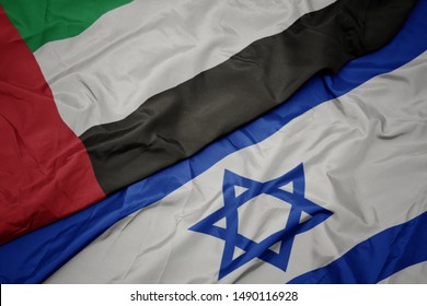 Waving Colorful Flag Of Israel And National Flag Of United Arab Emirates. Macro