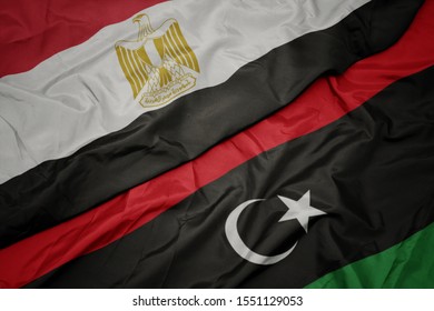 Waving Colorful Flag Of Libya And National Flag Of Egypt . Macro