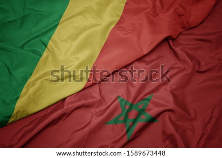 waving colorful flag of morocco and national flag of republic of the congo. macro