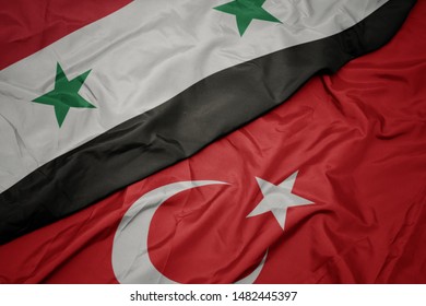 Waving Colorful Flag Of Turkey And National Flag Of Syria. Macro