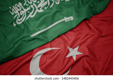 Waving Colorful Flag Of Turkey And National Flag Of Saudi Arabia. Macro