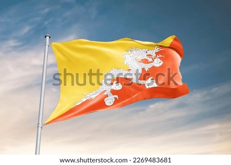 Waving flag of Bhutan in beautiful sky. Bhutan flag for independence day. The symbol of the state on wavy fabric.