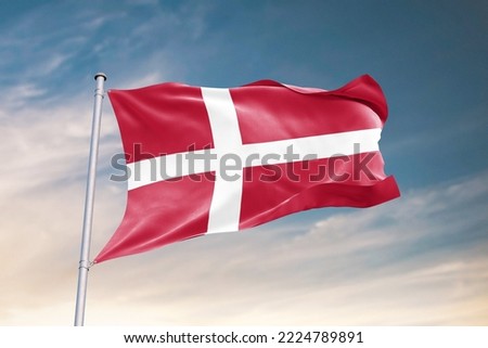 Waving Flag of Denmark in Blue Sky. Denmark Flag on pole for Independence day. The symbol of the state on wavy fabric.