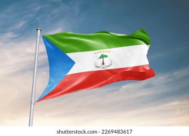 Waving flag of Equatorial Guinea in beautiful sky. Equatorial Guinea flag for independence day. The symbol of the state on wavy fabric.