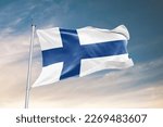 Waving flag of Finland in beautiful sky. Finland flag for independence day. The symbol of the state on wavy fabric.
