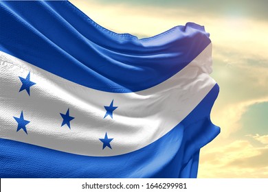 Waving Flag of Honduras in Blue Sky. Honduras Flag on pole for Independence day. The symbol of the state on wavy cotton fabric.