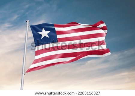 Waving flag of Liberia in beautiful sky. Liberia flag for independence day. The symbol of the state on wavy fabric.