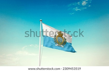 Waving flag of San Marino in beautiful sky. San Marino flag for independence day.