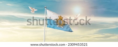 Waving flag of San Marino in beautiful sky. San Marino flag for independence day.