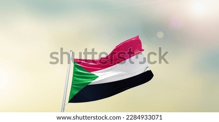 Waving flag of Sudan in beautiful sky. Sudan flag for independence day.