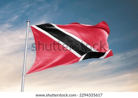 Waving flag of Trinidad and Tobago in beautiful sky. Trinidad and Tobago flag for independence day. The symbol of the state on wavy fabric.
