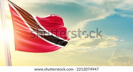 Waving Flag of Trinidad and Tobago in Blue Sky. The symbol of the state on wavy cotton fabric.