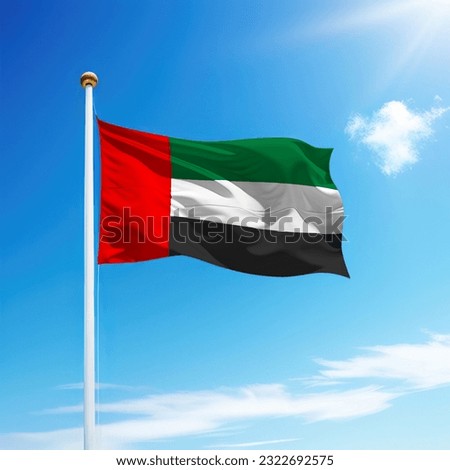 Waving flag of United Arab Emirates on flagpole with sky background. Template for independence day