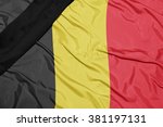 waving national flag of belgium with black mourning ribbon 