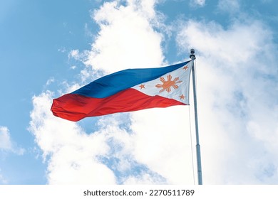 waving philippine flag in a pole with clouds and blue sky background - Powered by Shutterstock