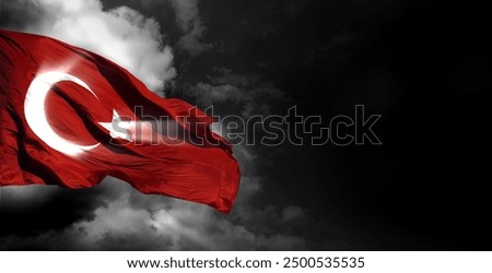 The waving Turkish flag and dark cloud