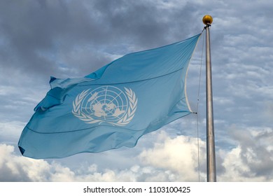 Waving United Nations UN Flag In The Deep Blue Sky Background