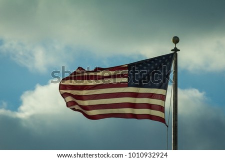 Waving usa flag in front of cloudy sky
