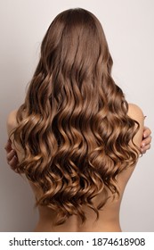 Wavy  Brown Hair Back View. Grey Background