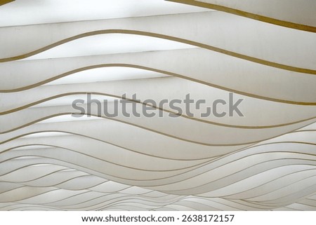 Wavy, layered panels create a dynamic, abstract pattern, playing with light and shadow.