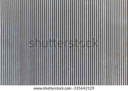 Wavy pattern, corrugated chrome metal sheet background.