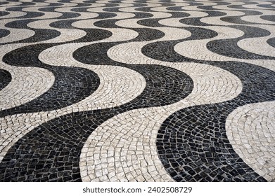 Wavy Pattern of Traditional Mosaic Tiles Pavement in Lisbon, Portugal.                             