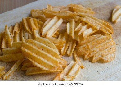 Wavy Potato Chips On Wood