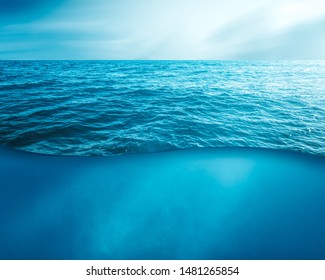 wavy sea water surface with sky and underwater  - Shutterstock ID 1481265854