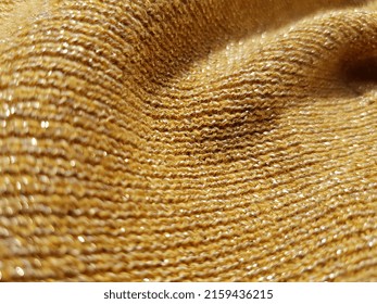 Wavy Yellow Sparkling Fabric With Metallic Shiny Threads - Lurex In The Sun, In Folds (macro, Knitted Elastic Band, Texture).
