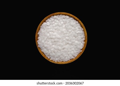 Wax resin on wooden plate. Beads wax pellets background. wax pallet isolated on black background. pe wax. - Powered by Shutterstock