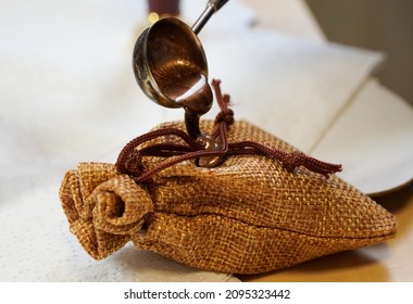 Wax sealmaking on a craft bag of linen. Man fingers. Handmade. . High quality photo