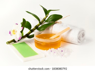 Wax Or Sugar Depilation Paste. Towel, Wax Strip, Sea Salt Scrub And Wooden Spatula. Hair Removal Or Professional Waxing Beauty Salon Concept. Space For Text.