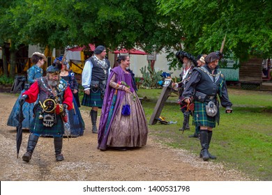 Waxahachie, Texas / USA - 11 May 2019
Scarborough Renaissance Festival
Two Men In Very Elaborate Scottish Costumes Trying To Avoid Stepping Into The Mud.