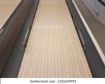 waxed wooden bowling alley lanes with bumpers