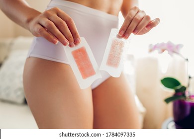 Waxing Bikini Area At Home. Young Sexy Woman Wearing Underwear And Holding Strips With Wax. Beauty Care Routine