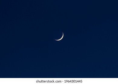 Waxing crescent moon in a dark blue night sky in spring - Powered by Shutterstock