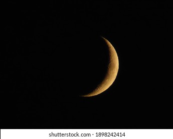 Waxing crescent moon in a dark sky
