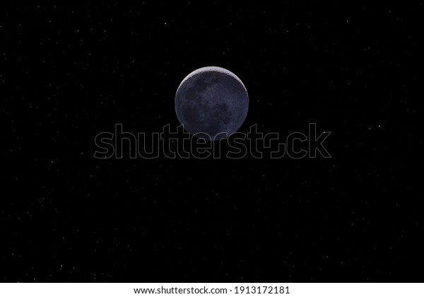 Waxing crescent moon with a night sky stars\
background. Amazing view of the tiny moon surface illuminated by\
the sun and the dark side of the moon. Dramatical thin line cut out\
in the starry\
nighsky\
\
