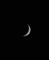 Waxing Cresent Moon Phase on Black Background, a Background Photo by nina1039