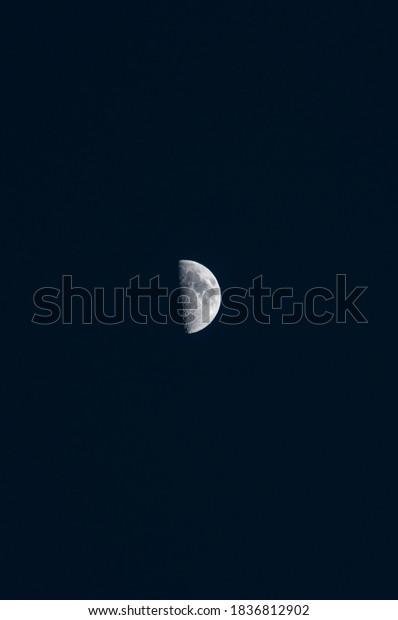 waxing quarter moon in a\
deep blue sky