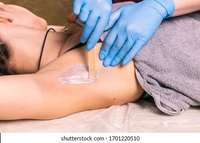 Waxing Woman Armpit. Salon Wax Beautician Epilation Procedure. Waxing Female Body For Hair Removal By Therapist Close Up. Smooth Underarm Concept.